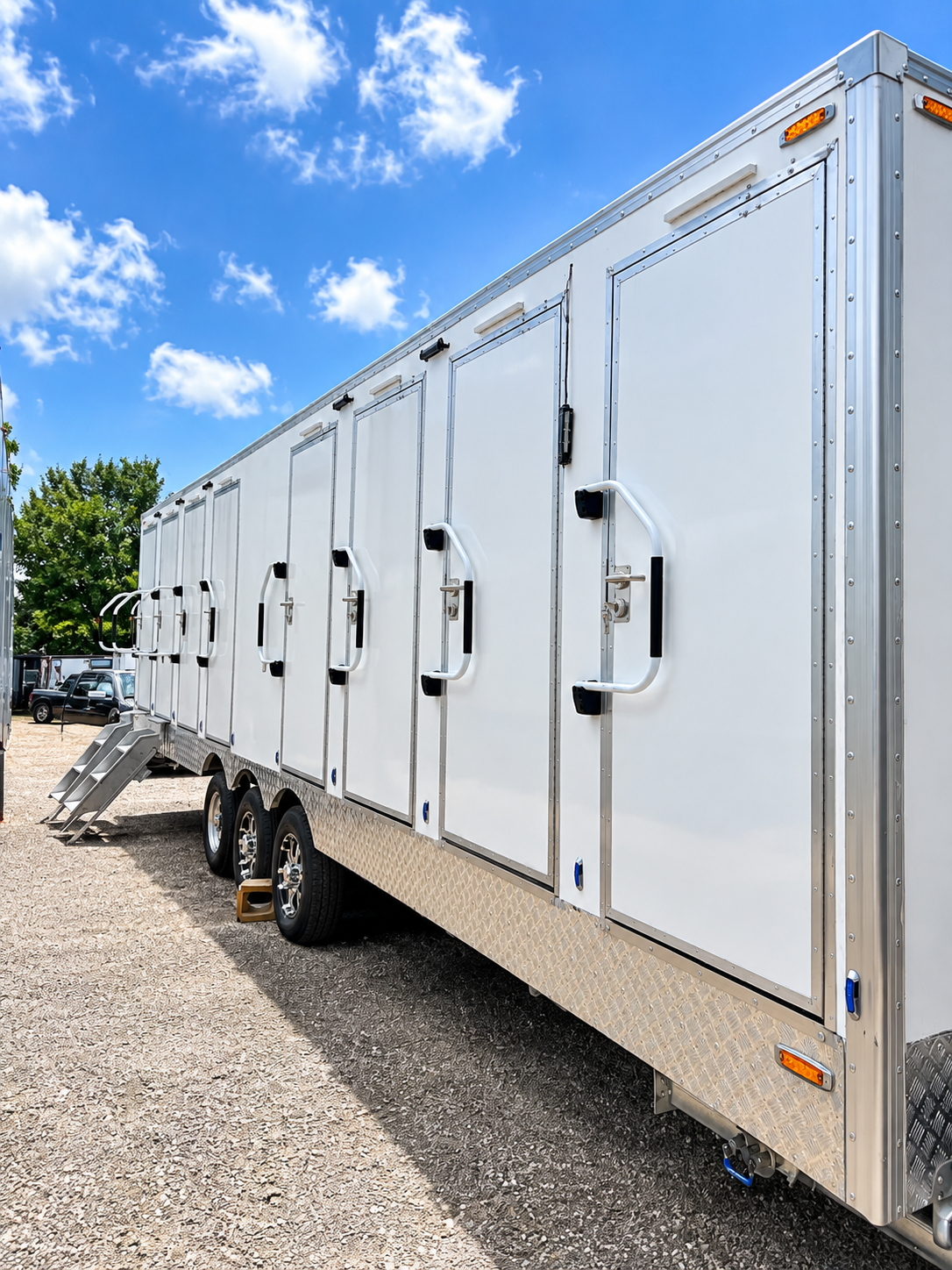 Exterior side view of a 30 ft eight-stall shower and restroom combination trailer