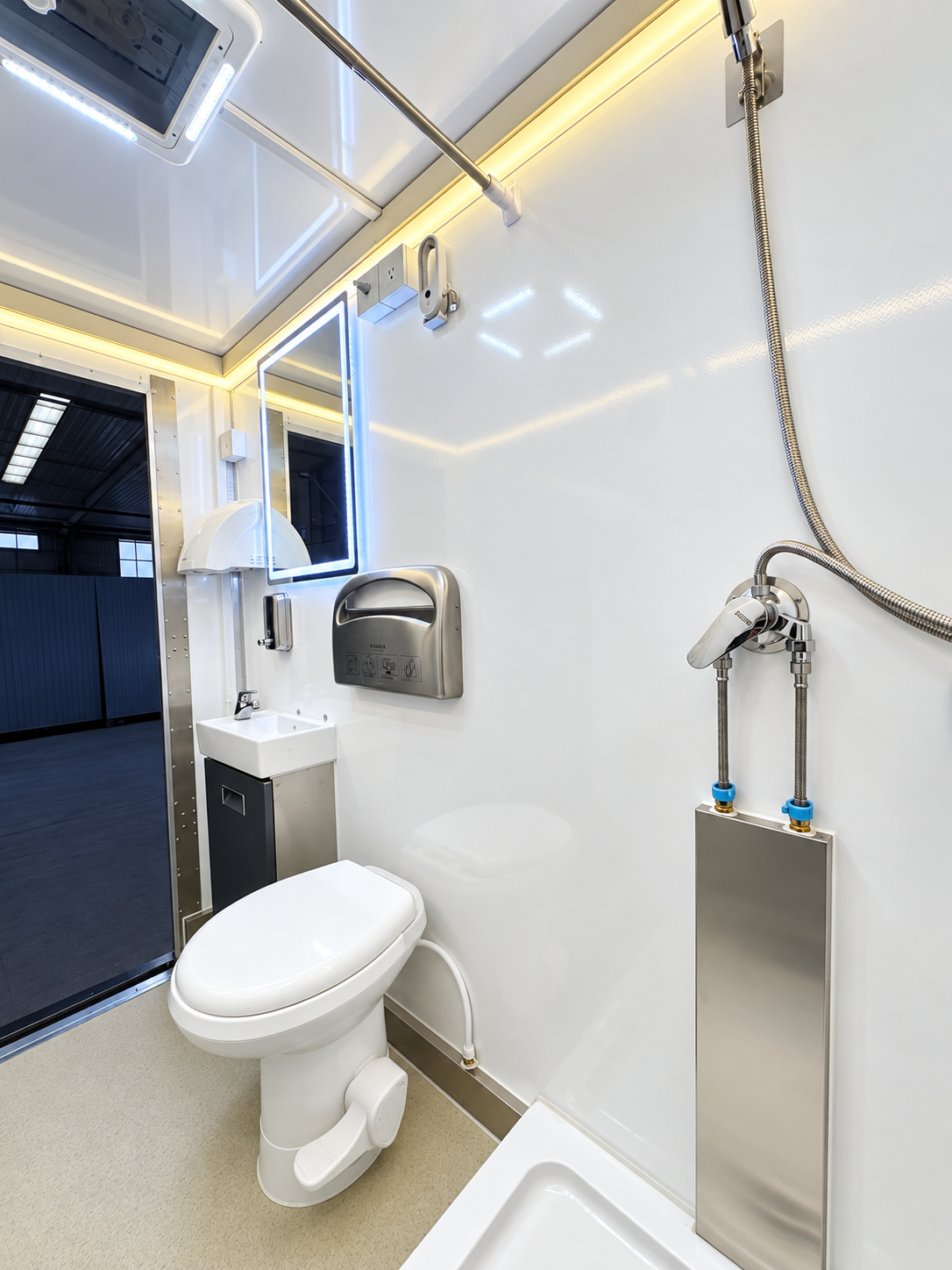 Interior of a three-stall plus one ADA luxury shower and restroom combination trailer